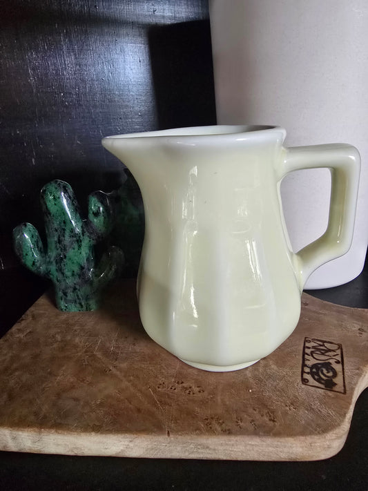 Coffee shop creamer, made in the USA.  Light yellow